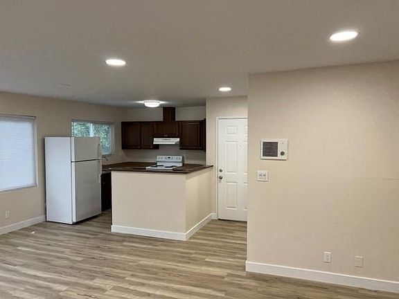 Kitchen adjacent to large room for living and dining