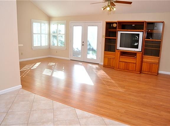 View of living room and back door. Nice and bright. Entertainment cabinet is included!