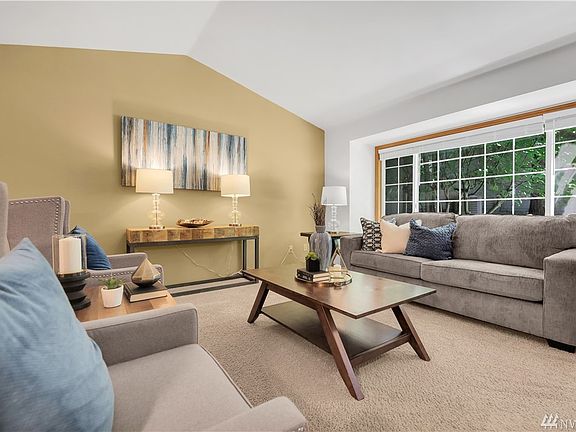 Formal seating area features high ceilings that create an open and airy feeling. 