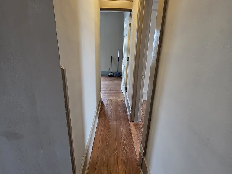 Next view of hallway with bedroom 3 on the right and bedroom 4 straight ahead.