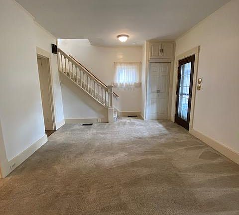 View from fireplace. Front hall closet and upper storage.