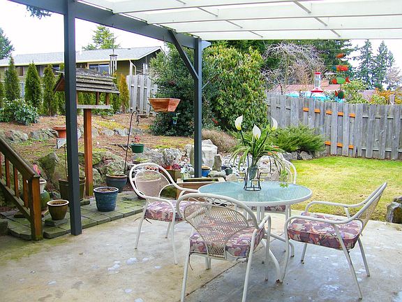 Back covered patio is huge; two lawn areas, terraced planting