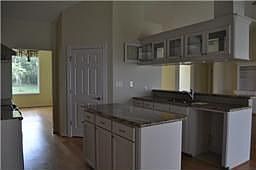 Kitchen w/corian countertops, island & snack bar