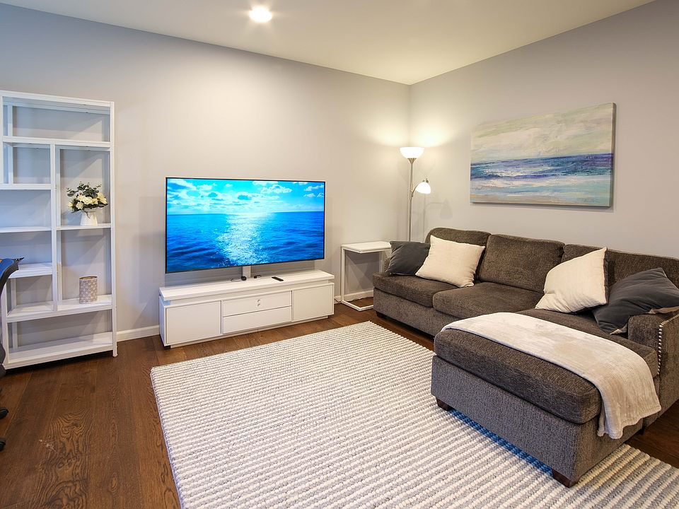 Living room with sleeper couch and 65" Smart TV