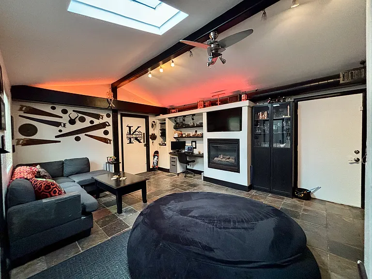 Shared den with fireplace, tv, couch, giant bean bag, wet bar
