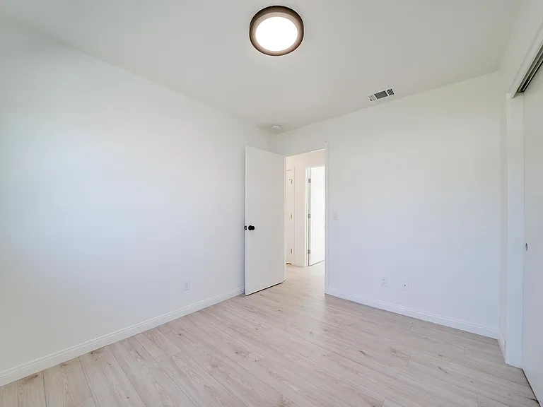 4th bedroom. New paint, blinds, flooring, light fixtures. Closet on the left, new handles will be installed.