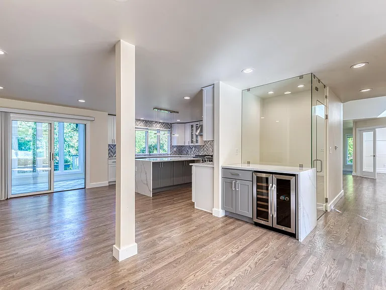 View from the dining area to the bar, wine cellar, living room and kitchen
