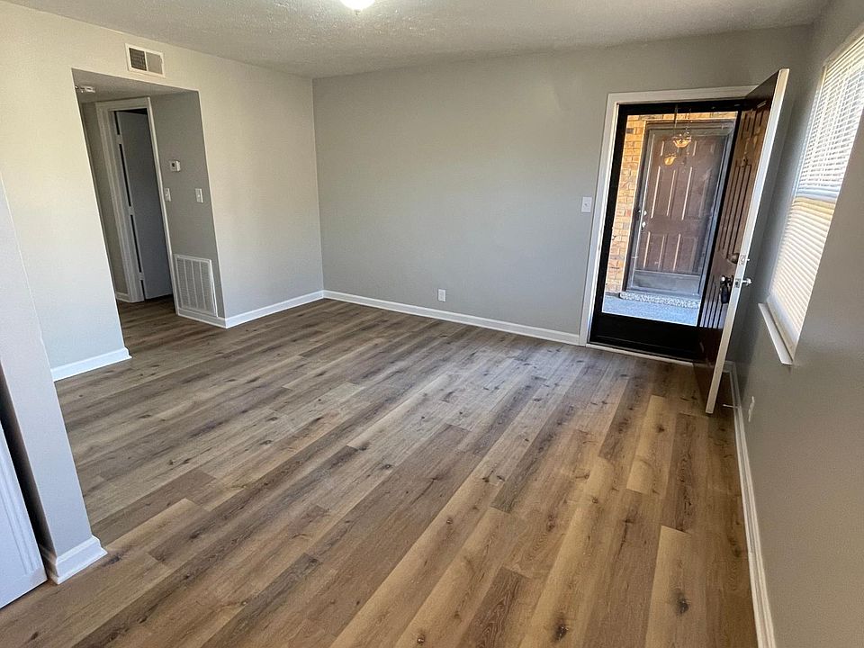 Kitchen looking into living room and entry door