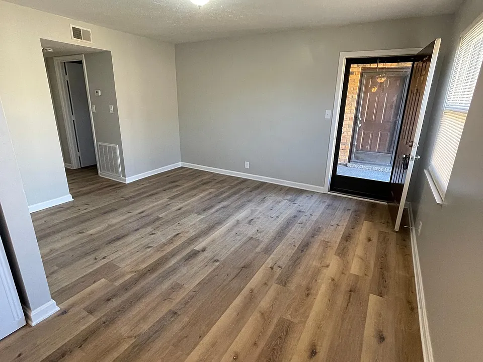 Kitchen looking into living room and entry door