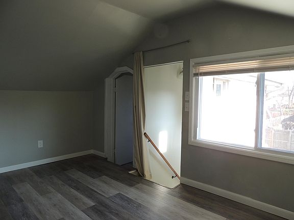Bedroom/kitchen (facing bathroom door and staircase to entry door)