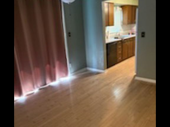 Dining area, wood flooring, ceiling fan and back patio sliding glass doors. Food storage pantry not in picture