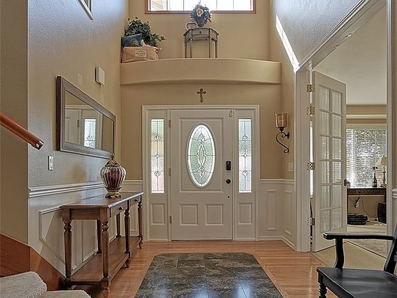 Beautiful entrance to the foyer with 18 ft ceiling and grand staircase.