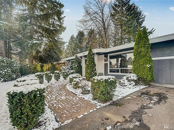 Welcoming paver walkway to the front door, gorgeous trees surround property. 