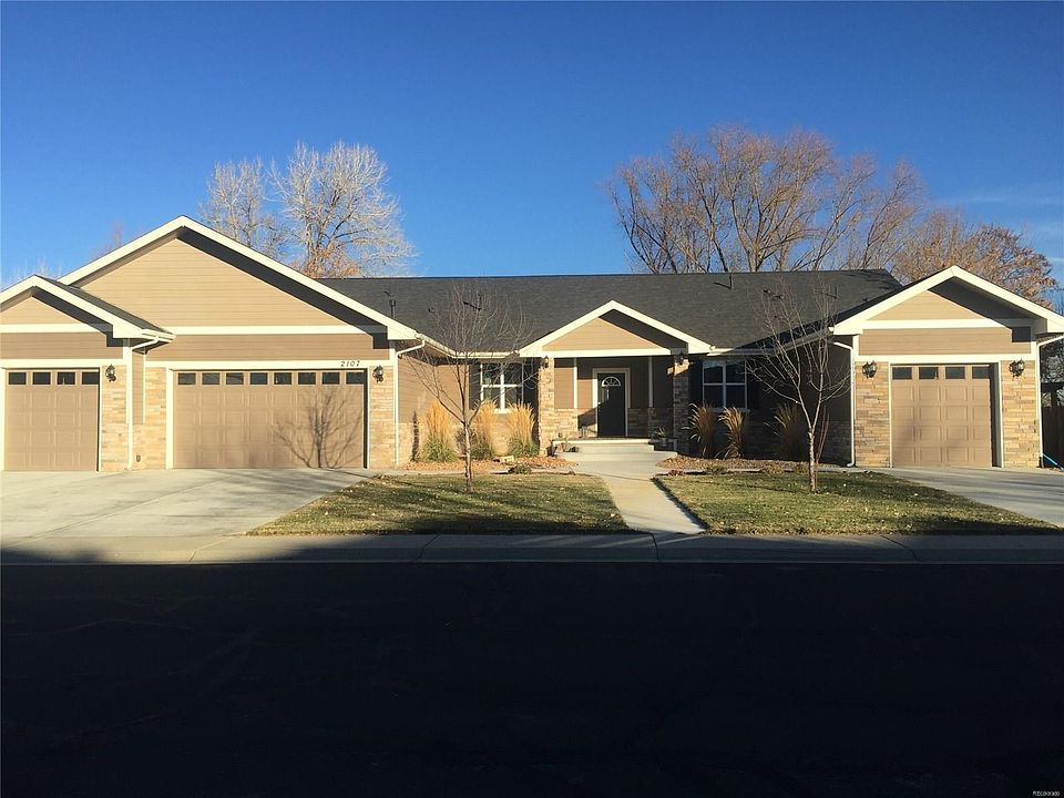 Front view of home with a 4 car attached garage with extra tall garage doors.