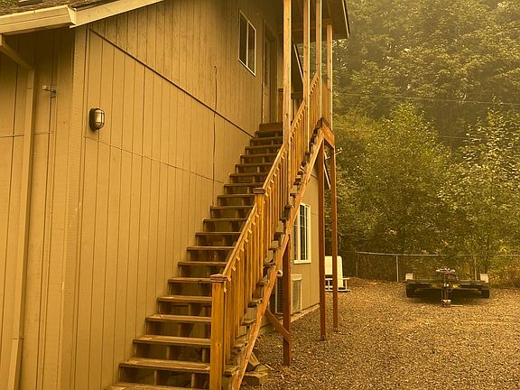Entrance is behind the building up this staircase