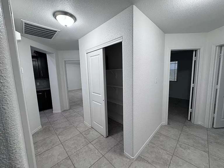 hallway connecting to kitchen, master, and guest bedrooms 1 & 2.