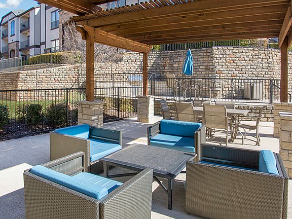 Outdoor lounge area with covered seating and modern patio furniture