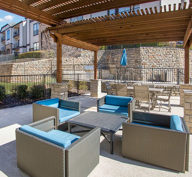 Outdoor lounge area with covered seating and modern patio furniture
