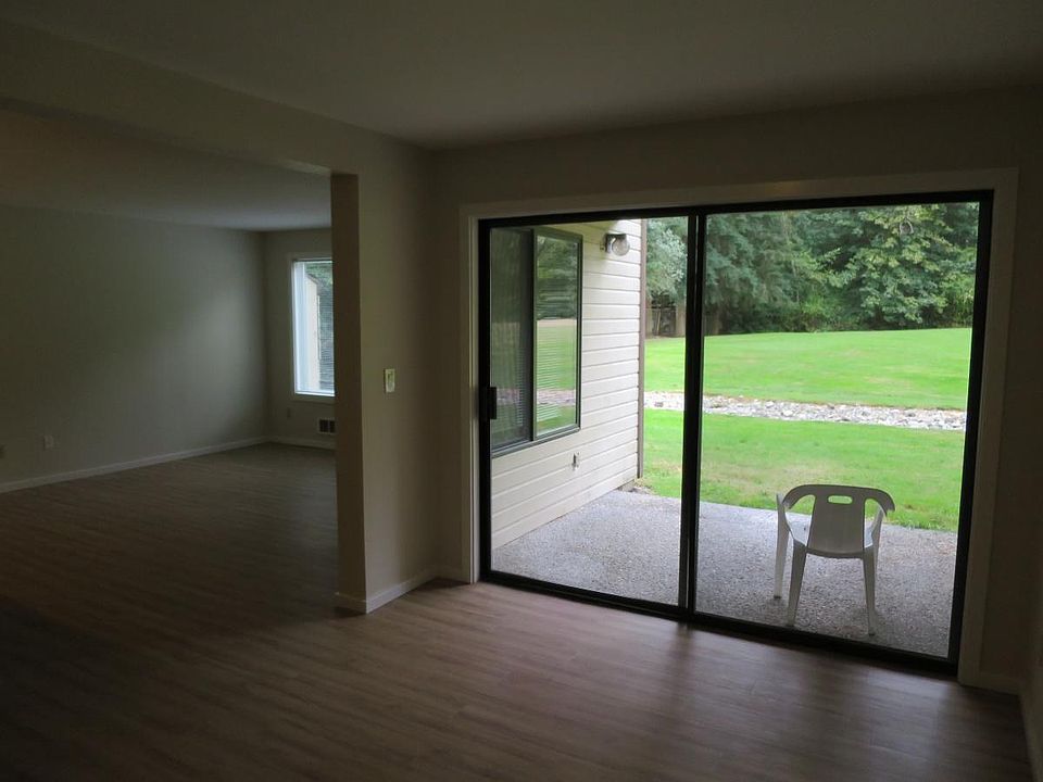 Living room and dining room have a view of the large greenbe
