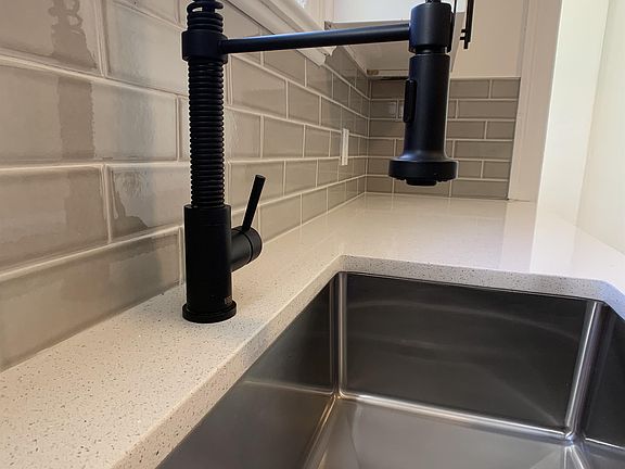 New matte black telescoping faucet and deep stainless steel sink