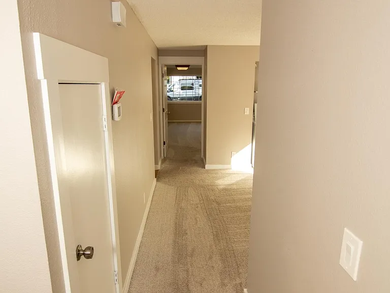 Long hallway from downstairs bedroom to laundry/home office, and ending in the 450 sq ft bonus room.