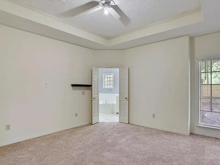 Master bedroom, window, entrance to master bathroom