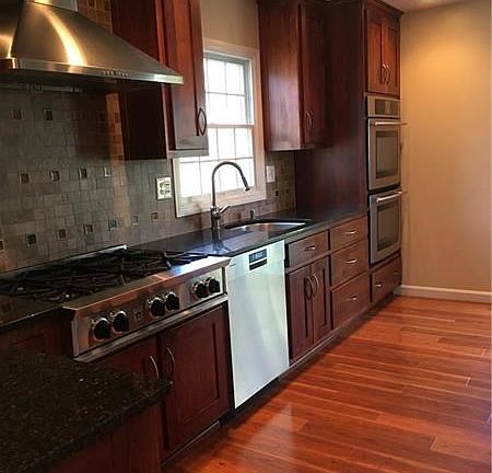 From dining room into kitchen. A good view of the custom cabinets, large drawers in lower cabinets, and Italian custom tile desi