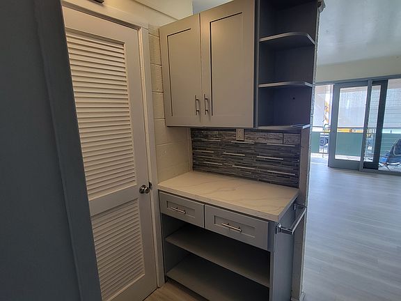 From entrance looking left towards pantry area and closed bathroom door