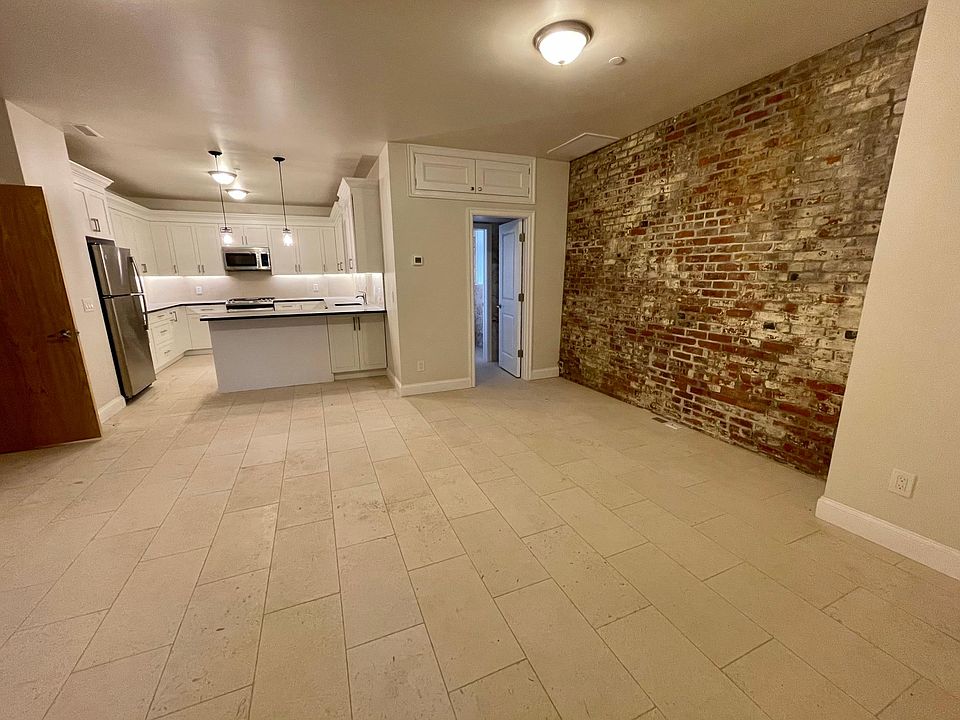 Kitchen / Living Open Concept Area with Imported Stone Tile and Brick Accent Wall