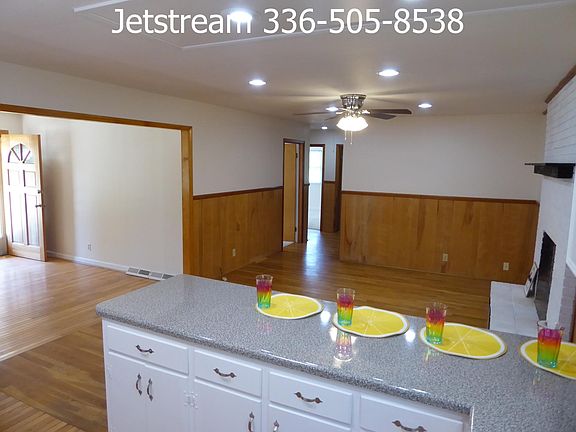 Open kitchen and den with bar seating