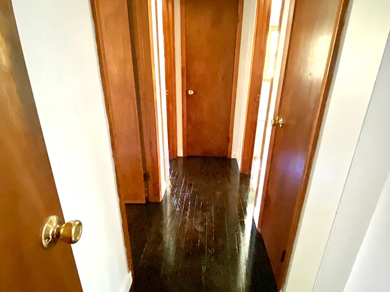 Hallway with 3 storage closets