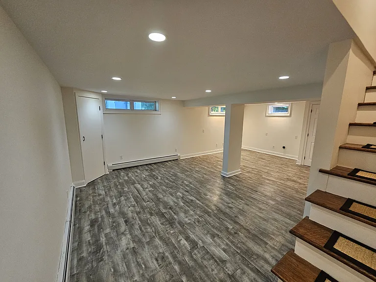Basement Living Area _ View 1
Finished basement living area with recessed lighting, durable flooring, and direct access from the main-level staircase.