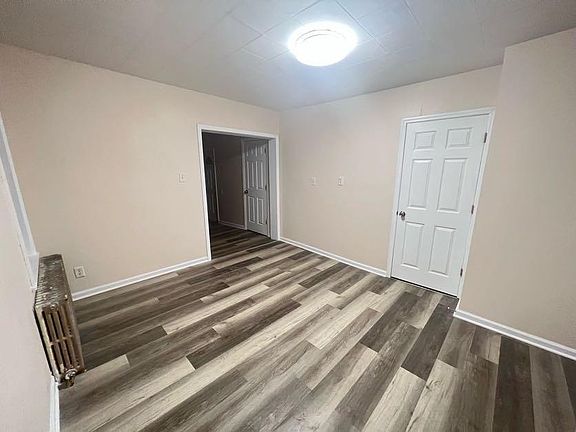 (Living room 2/3) Large entrance leads to the 3rd bedroom, kitchen, and porch.