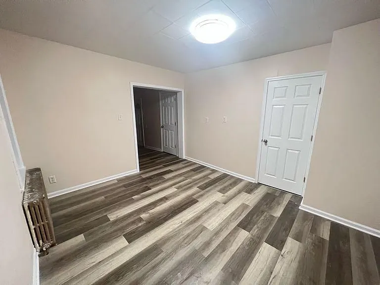 (Living room 2/3) Large entrance leads to the 3rd bedroom, kitchen, and porch.