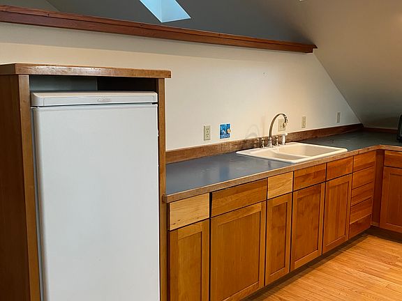 Kitchenette with toaster oven, microwave, coffee pot and kitchen utensils