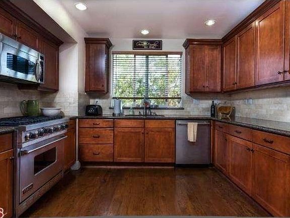 Kitchen with Viking stove/oven. Microwave, dishwasher, built-in fridge.