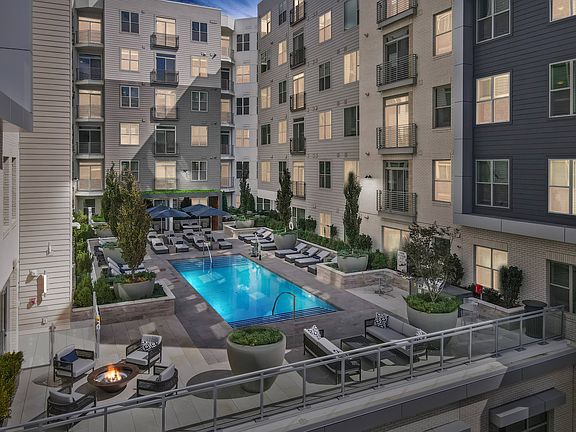 Resort-style pool with pool-side seating, dining, grilling stations and firepit