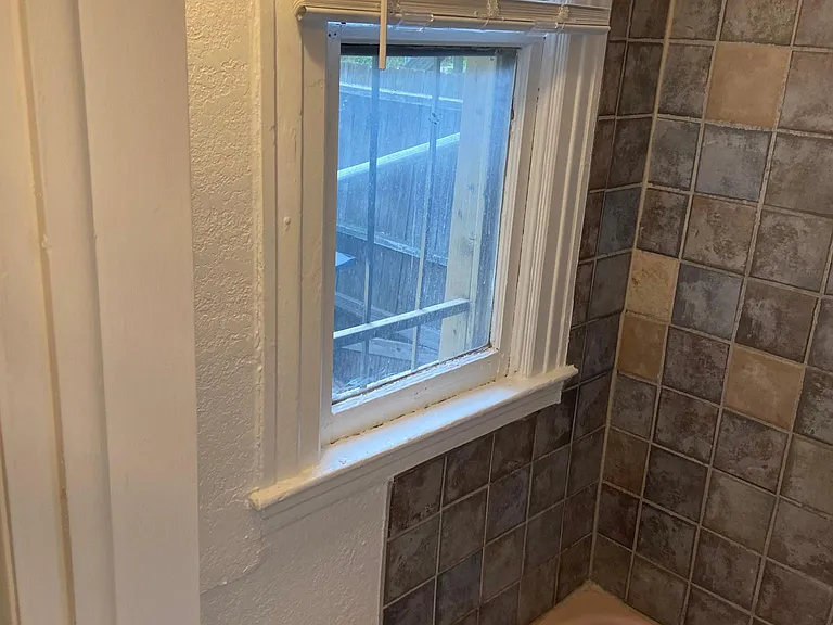 Far left of the bathroom