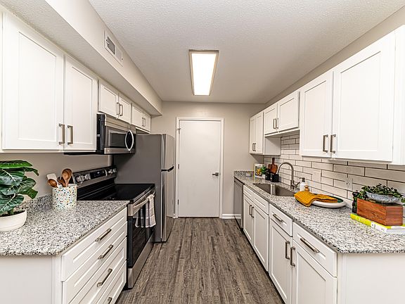 Kitchen with granite counters, modern cabinetry, and stainless steel appliances