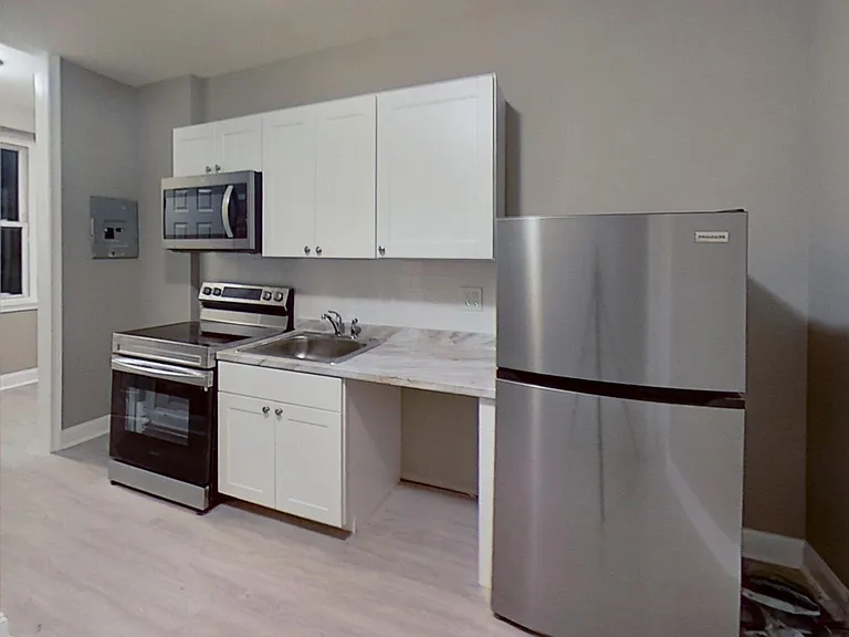 Kitchen from the unit upstairs, the same appliances will be installed in the 1st Floor -- Unit 1