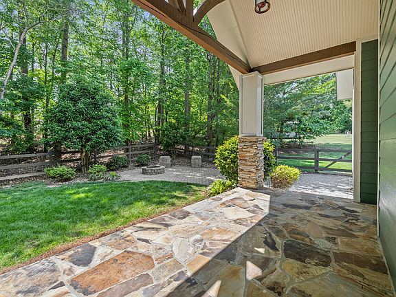 Real flagstone backyard porch with gable ceiling.