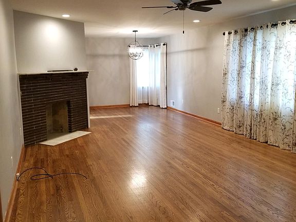 Standing in the family room and looking toward the dining room, a doorway on the left of the dining room leads to the kitchen