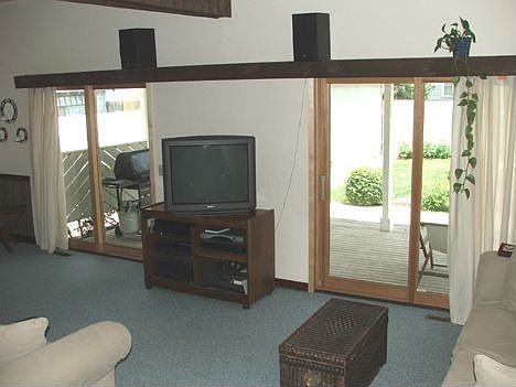 Family room features extra tall ceilings and 2 Pella doors to back deck.