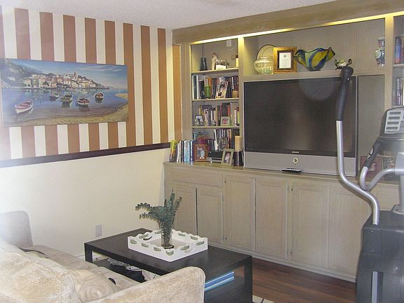 downstairs bedroom used as family foorroom with builtins