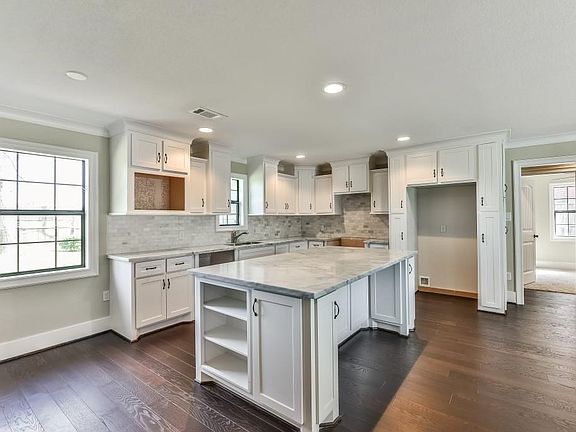 No Detail Was Spared In This Custom Kitchen Which Includes Carrera Marble Counters, Shaker Style Cabinet Doors With Drawer Pulls and Carrerra Marble Backsplash.