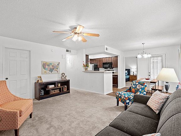 Carpeted Living Room with Ceiling Fan