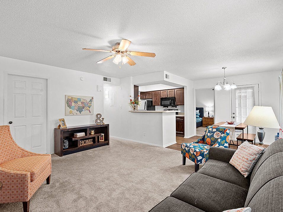 Carpeted Living Room with Ceiling Fan