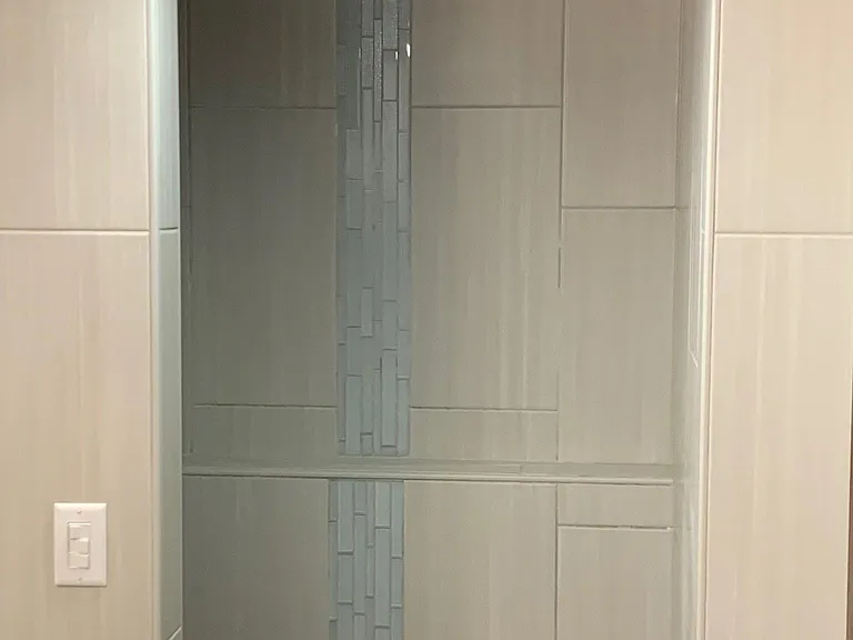 Walk-in tile shower in lower level