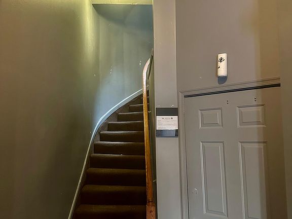 Entry of the building. Steps leading to the second floor, which is includes apartment 2 as the only unit on the floor. The hallway is well lighted.