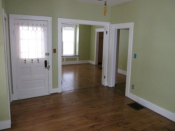 Living room, view to dining room. Exterior door shown is not used; actual front door enters into dining room